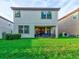 Two story house with covered patio and grassy backyard at 12874 Burns Dr, Odessa, FL 33556