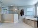 Elegant bathroom featuring a soaking tub and a glass-enclosed shower at 12874 Burns Dr, Odessa, FL 33556