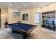 Game room featuring a pool table, comfortable seating, and bookshelves at 10505 Inglenook Ter, Palmetto, FL 34221