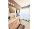 Bright bathroom features patterned wallpaper, vanity with sink, toilet, and shower with themed shower curtain at 2256 Philippine Dr # 46, Clearwater, FL 33763