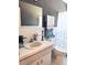 Bright bathroom features patterned wallpaper, vanity with sink, toilet, and shower with themed shower curtain at 2256 Philippine Dr # 46, Clearwater, FL 33763