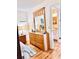 Bedroom featuring updated flooring and dresser, and view into bathroom at 2256 Philippine Dr # 46, Clearwater, FL 33763