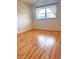 Bedroom with wood-look flooring, window with curtains, and neutral walls at 2256 Philippine Dr # 46, Clearwater, FL 33763