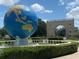 World globe statue on a base featuring a manicured shrubbery surrounding the monument at 2256 Philippine Dr # 46, Clearwater, FL 33763