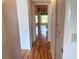 Hallway featuring updated flooring and view into adjacent bedrooms at 2256 Philippine Dr # 46, Clearwater, FL 33763