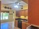 Eat in kitchen features hardwood floors, wood cabinets, and decorative pendant lights at 2256 Philippine Dr # 46, Clearwater, FL 33763