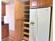 Kitchen featuring pull out shelving, wooden cabinets and modern refrigerator at 2256 Philippine Dr # 46, Clearwater, FL 33763