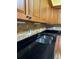 Kitchen counter featuring stone backsplash, stainless sink, and black countertop at 2256 Philippine Dr # 46, Clearwater, FL 33763