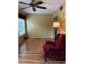 Cozy living room with laminate flooring, large window, and inviting armchair at 2256 Philippine Dr # 46, Clearwater, FL 33763