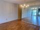 A sunlit living room offers beautiful hardwood floors and a full wall mirror reflecting outdoor views at 2256 Philippine Dr # 46, Clearwater, FL 33763