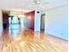 A spacious living room features mirrored wall, wood floors, and a ceiling fan at 2256 Philippine Dr # 46, Clearwater, FL 33763
