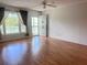 Bright living room with wood floors, natural light from large windows, and a ceiling fan at 2256 Philippine Dr # 46, Clearwater, FL 33763