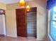 Pantry with adjustable shelving, wooden doors, and modern hanging lights nearby at 2256 Philippine Dr # 46, Clearwater, FL 33763