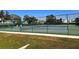 Community tennis courts surrounded by a green fence at 2256 Philippine Dr # 46, Clearwater, FL 33763