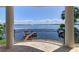 Covered balcony offers stunning views of the water, a private dock, and tropical foliage at 6627 Bayou Grande Ne Blvd, St Petersburg, FL 33702