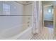 Bathroom features a tiled bathtub and black-and-white patterned floor at 6627 Bayou Grande Ne Blvd, St Petersburg, FL 33702