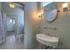 Bright bathroom featuring stylish fixtures, a round mirror, and a tiled floor at 6627 Bayou Grande Ne Blvd, St Petersburg, FL 33702