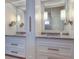 Elegant dual vanity bathroom with granite countertops, and decorative lighting at 6627 Bayou Grande Ne Blvd, St Petersburg, FL 33702