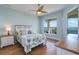 Light-filled bedroom with hardwood floors, ceiling fan, and a water view from the window at 6627 Bayou Grande Ne Blvd, St Petersburg, FL 33702