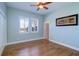 Cozy bedroom with hardwood floors, a ceiling fan, and ample natural light from windows with plantation shutters at 6627 Bayou Grande Ne Blvd, St Petersburg, FL 33702