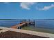 Private dock extending into the water, ideal for boating and waterfront activities on a clear day at 6627 Bayou Grande Ne Blvd, St Petersburg, FL 33702