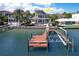 Elegant waterfront home with a private dock and a swimming pool, showcasing luxurious outdoor living at 6627 Bayou Grande Ne Blvd, St Petersburg, FL 33702