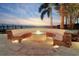 Waterfront backyard with an outdoor fire pit and bench seating with views of the bay at 6627 Bayou Grande Ne Blvd, St Petersburg, FL 33702