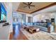 Open-concept living room featuring a staircase, kitchen, and modern decor at 6627 Bayou Grande Ne Blvd, St Petersburg, FL 33702