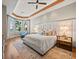 Bright main bedroom featuring a bay window with water views, and tray ceiling with recessed lighting at 6627 Bayou Grande Ne Blvd, St Petersburg, FL 33702