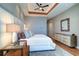 Stylish main bedroom featuring hardwood floors, modern furniture, and a decorative mirror at 6627 Bayou Grande Ne Blvd, St Petersburg, FL 33702