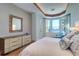 Spacious main bedroom with water views, modern furniture, and hardwood floors at 6627 Bayou Grande Ne Blvd, St Petersburg, FL 33702