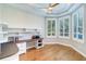 Bright office space featuring built-in desk and shelving, complemented by natural light from shuttered windows at 6627 Bayou Grande Ne Blvd, St Petersburg, FL 33702