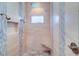 Luxurious walk-in shower featuring a pebble floor and a built-in bench at 6627 Bayou Grande Ne Blvd, St Petersburg, FL 33702