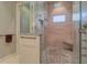 Walk-in shower with pebble flooring, bench, and tiled walls at 6627 Bayou Grande Ne Blvd, St Petersburg, FL 33702