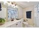 Bright bathroom featuring a modern vanity, a large mirror, and a shower with a stylish floral curtain at 2305 N Tampania Ave, Tampa, FL 33607