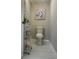 Cozy half-bathroom boasts soft colors, tiled flooring, and decorative artwork at 2305 N Tampania Ave, Tampa, FL 33607