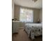 Comfortable bedroom with a quaint side table and soft lighting from a window at 2305 N Tampania Ave, Tampa, FL 33607