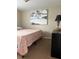 Bedroom with beach art and bedside dresser at 2305 N Tampania Ave, Tampa, FL 33607