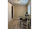 Cozy dining area featuring modern wood flooring, a simple table with cushioned seating, and natural light at 2305 N Tampania Ave, Tampa, FL 33607