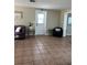 Cozy living room with a neutral color scheme, tile flooring, and a comfortable seating arrangement by the doorway at 2305 N Tampania Ave, Tampa, FL 33607