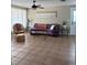 Inviting living room features tile flooring, a cozy sofa, and ample natural light streaming through sheer curtains at 2305 N Tampania Ave, Tampa, FL 33607