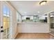 Kitchen with white cabinets, granite countertops, and access to backyard at 2305 N Tampania Ave, Tampa, FL 33607