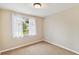 Bright bedroom with neutral walls, carpet flooring, and a window with sheer curtains at 2305 N Tampania Ave, Tampa, FL 33607