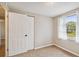 Bedroom with neutral walls, carpet flooring, and a large closet at 2305 N Tampania Ave, Tampa, FL 33607