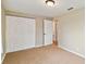 Spacious bedroom with double doors leading to a closet and hallway at 2305 N Tampania Ave, Tampa, FL 33607