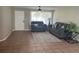 Living room with tiled floors, gray sofas, and a ceiling fan at 2305 N Tampania Ave, Tampa, FL 33607