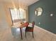 Dining area with ample natural light and views of the outdoor landscape, enhancing the dining experience at 103 Cypress Pond Rd # 103, Palm Harbor, FL 34683