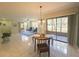 Open concept living space with dining area, sliding doors, and tile floors throughout at 103 Cypress Pond Rd # 103, Palm Harbor, FL 34683