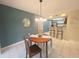 Dining area with a round table, stylish decor, and an open view to the kitchen at 103 Cypress Pond Rd # 103, Palm Harbor, FL 34683