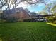 Home with a covered parking area and lush green lawn at 103 Cypress Pond Rd # 103, Palm Harbor, FL 34683